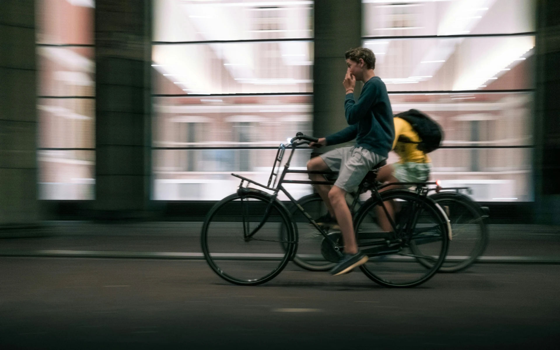 A cyclist riding through central Amsterdam