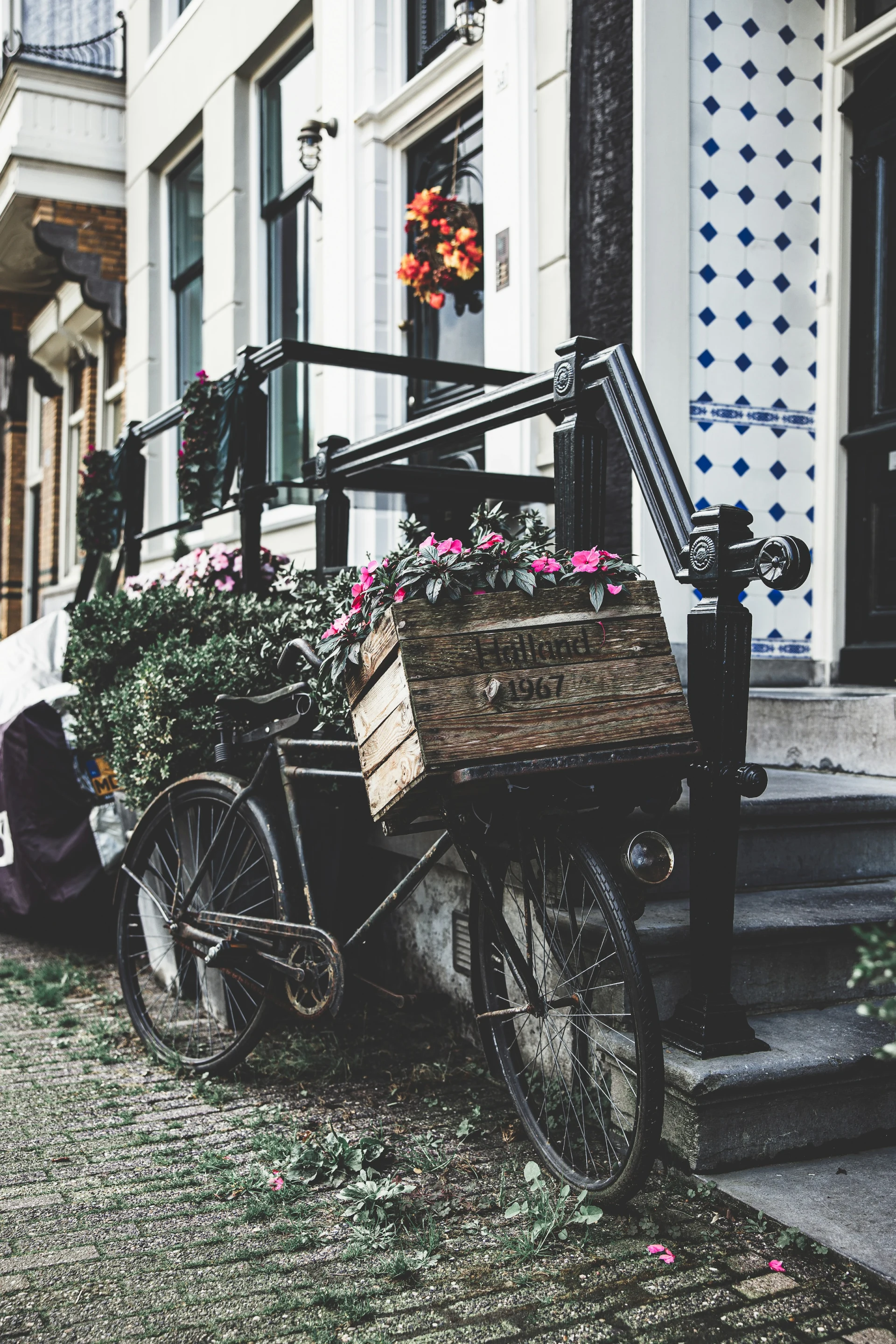 A bicycle with a flower box outside a canal house in the Jordaan