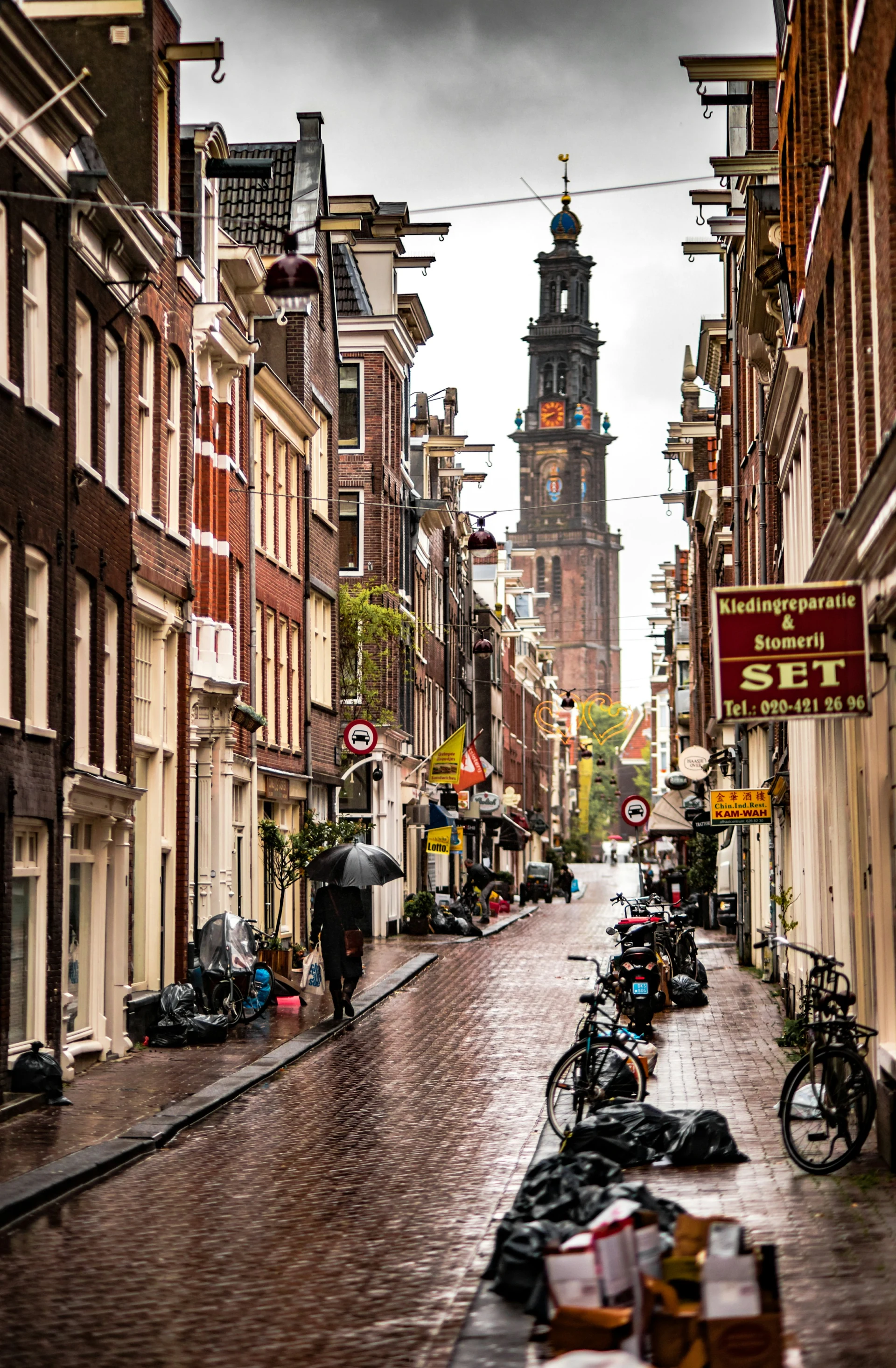 A narrow Amsterdam street lined with historic buildings